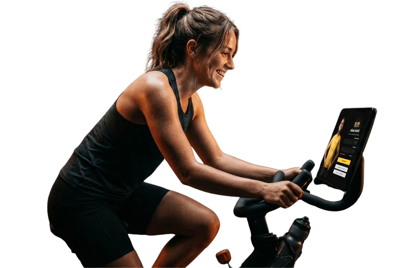 Mujer en bici estática siguiendo una clase de ciclo indoor de MoodCycling